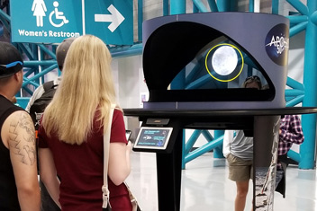 Visitors to The Kennedy Space Center view a Hologram Projector